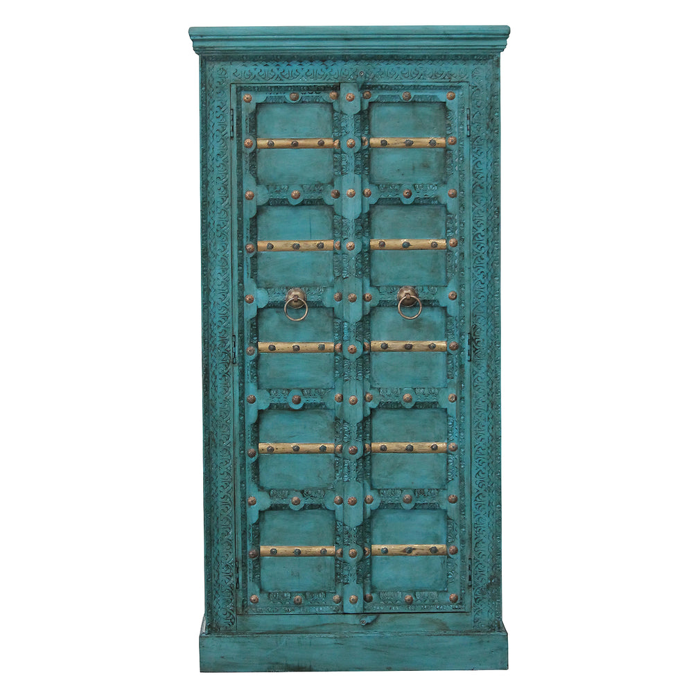 Vue de face de l’armoire turquoise en manguier massif, avec motifs sculptés et éléments décoratifs dorés.