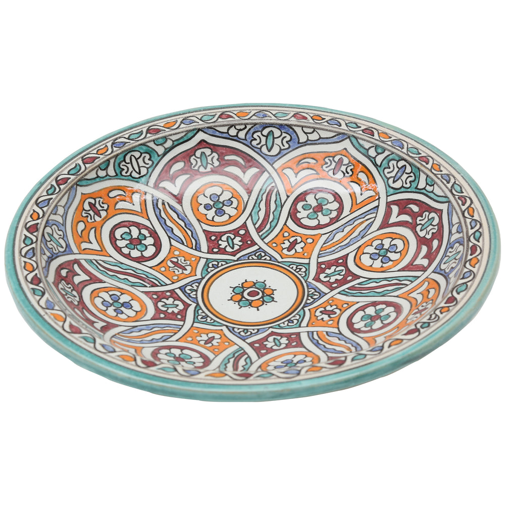 Bol en céramique peint à la main, orné d'un motif circulaire entrelacé dans les tons turquoise, orange et bordeaux