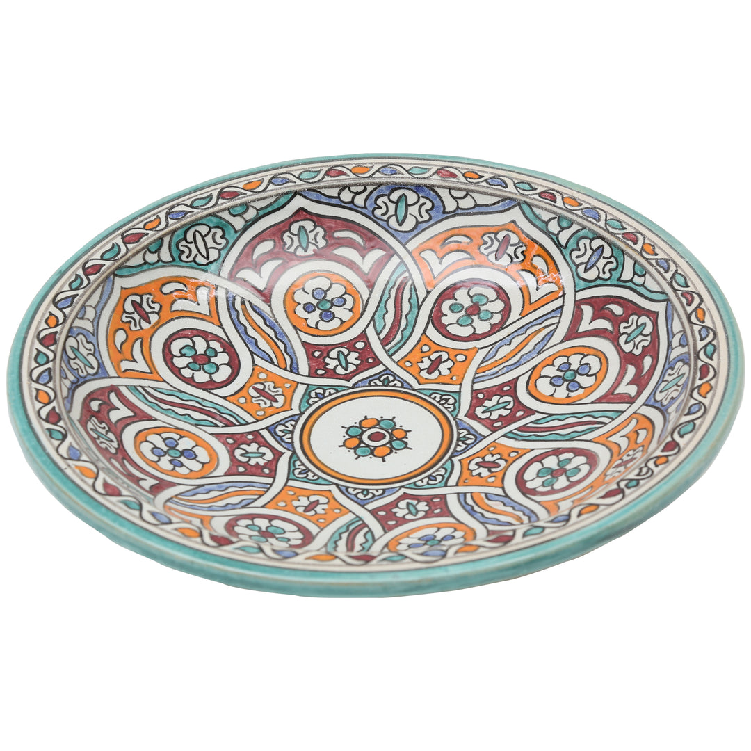 Bol en céramique peint à la main, orné d'un motif circulaire entrelacé dans les tons turquoise, orange et bordeaux